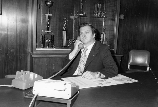 Joe Sr. on phone behind his desk