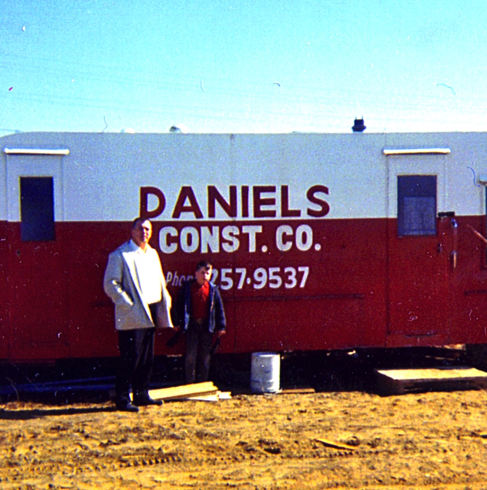 Joe M. Daniels and Jerry Daniels in front of trailer