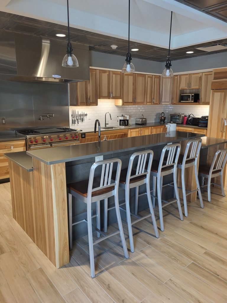 Remodeled kitchen area showcasing countertop seating area and new cabinets.